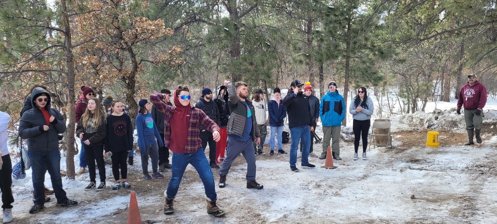 Youth and adults gathered outdoors in the snow